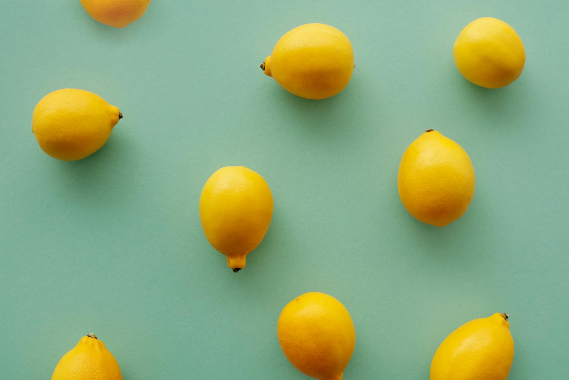 Bright yellow lemons arranged on a pastel background, symbolizing fresh vitality and natural stimulation