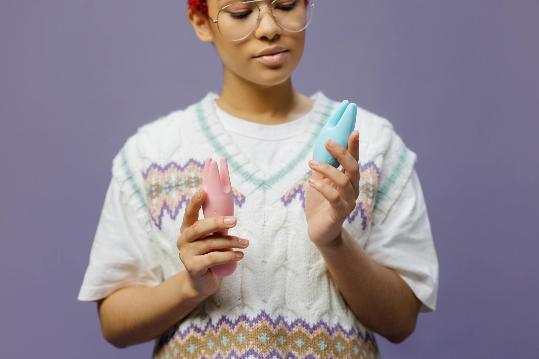 Woman thoughtfully holding a lemon vibrator and considering intimacy during stressful time